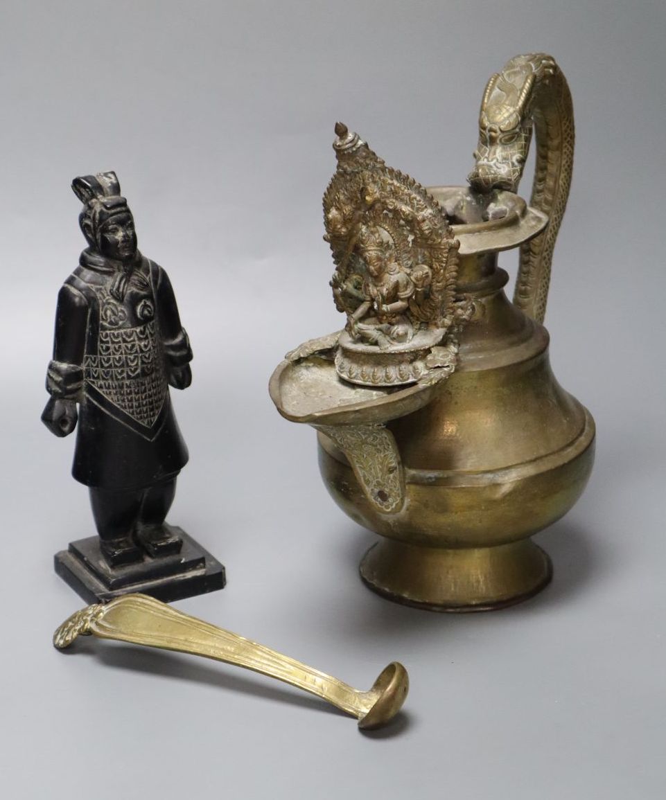 A Himalayan Buddhist brass lamp/ewer with related ladle, 26cm, 19th/20th century and a carved black mineral Chinese stone figure